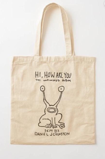 🔥 Tote Bag Daniel Johnston – Hi, How Are You | 100% Algodón, Beige, Diseño Icónico 🎶 - Trazzo Studio